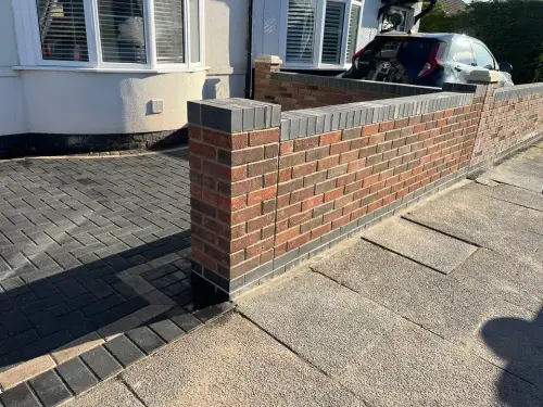 Block paved drive with a brick front wall