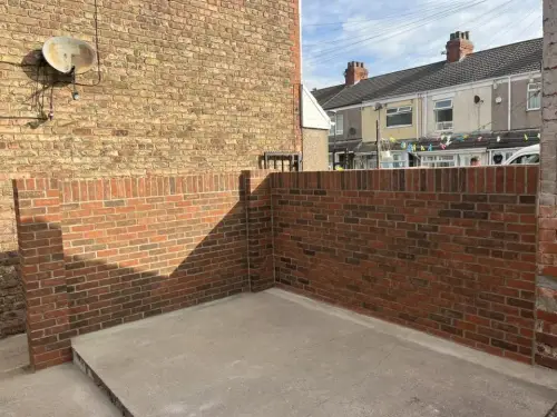 New brick boundary wall in a rear yard