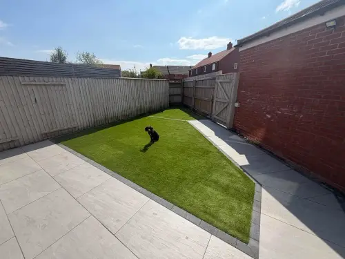 Light porcelain paving with an artificial grass strip