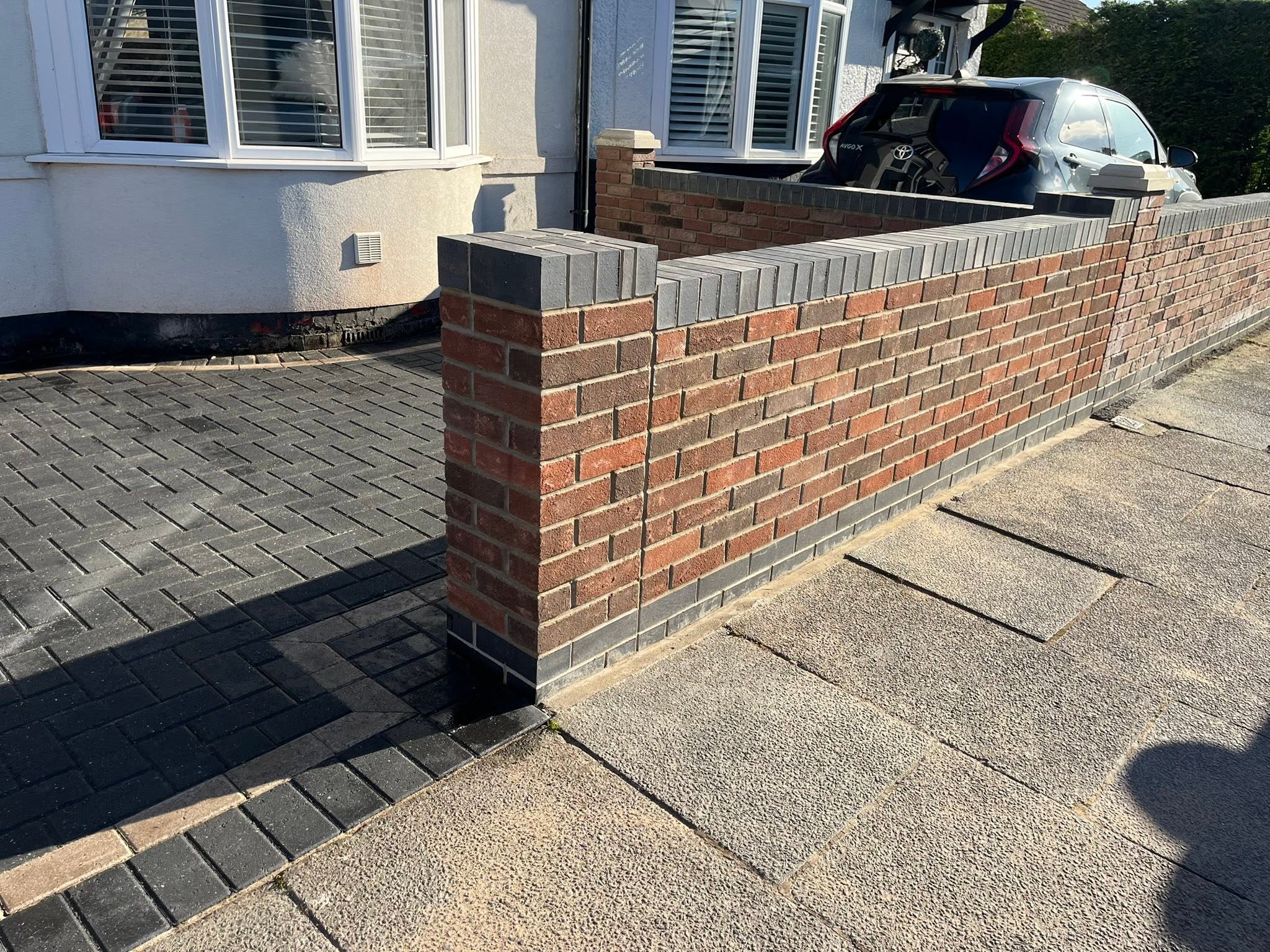 Brick front wall with block paved drive