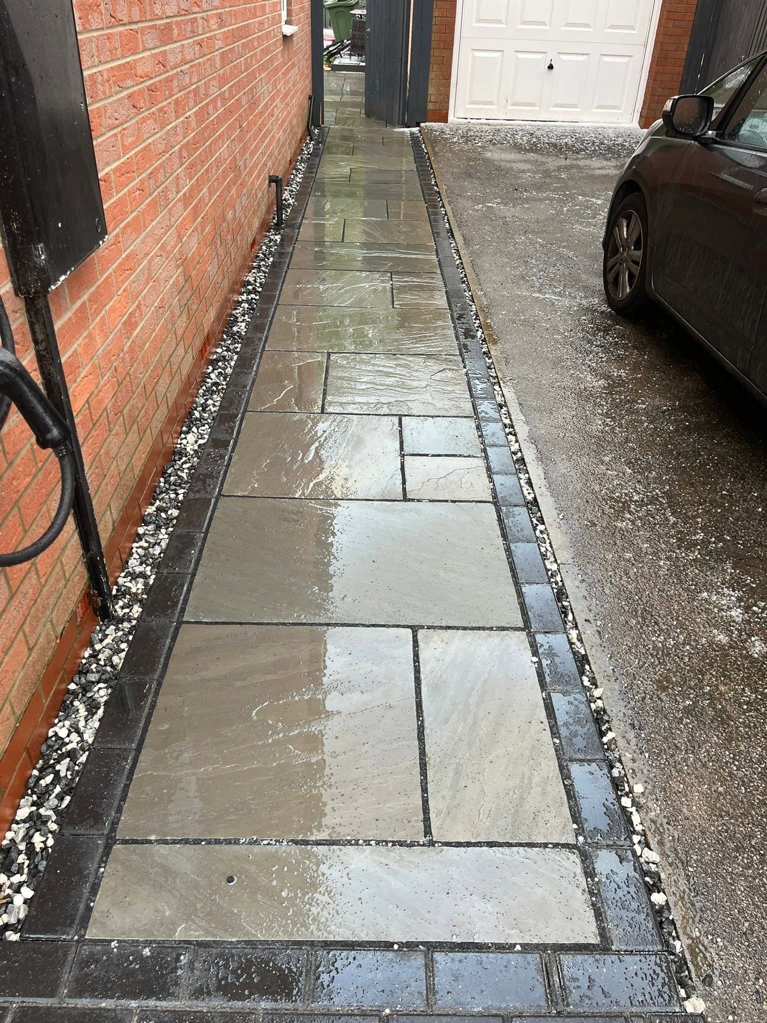 Grey slab side path with block edging