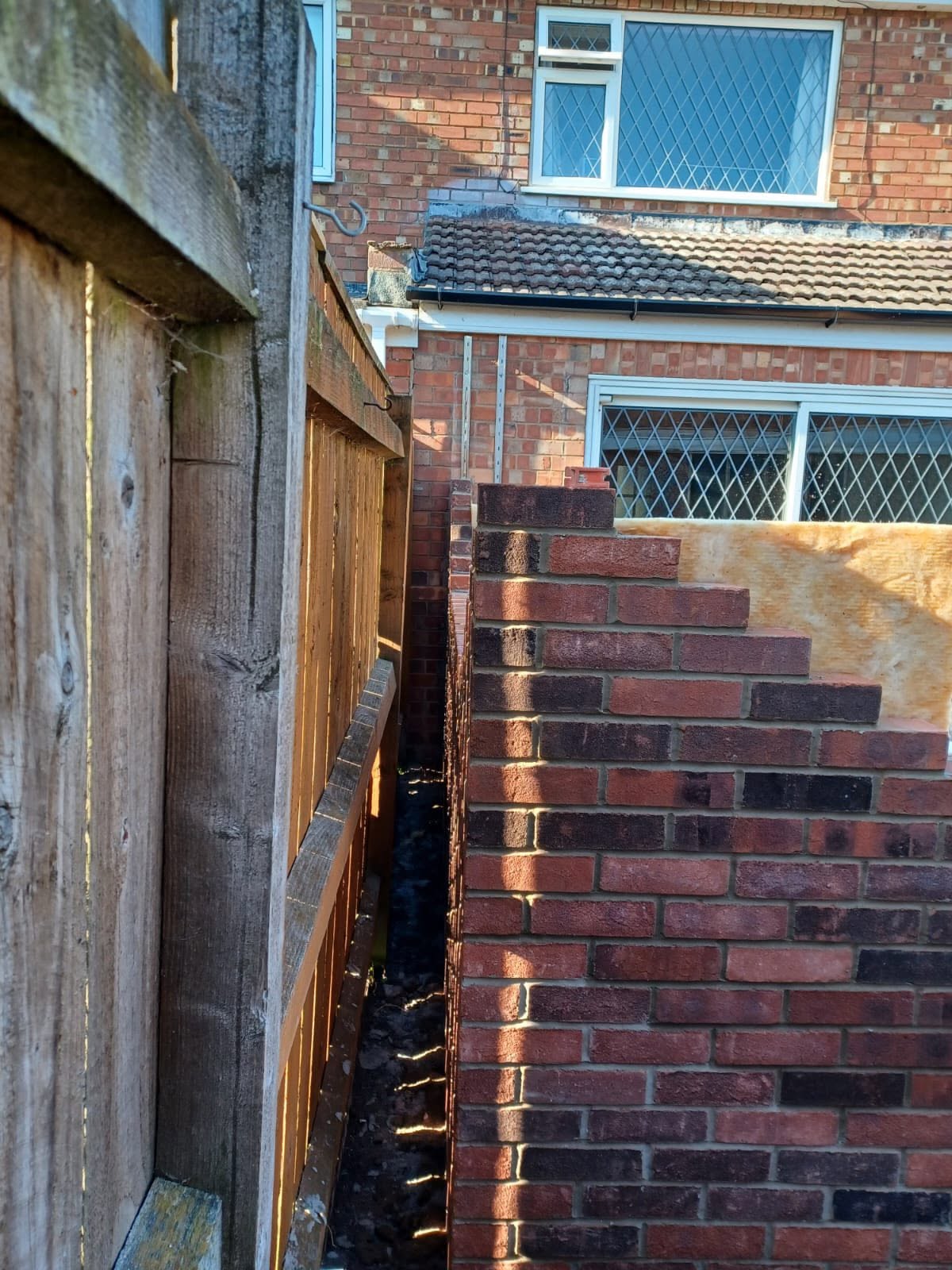 Brick boundary wall being built