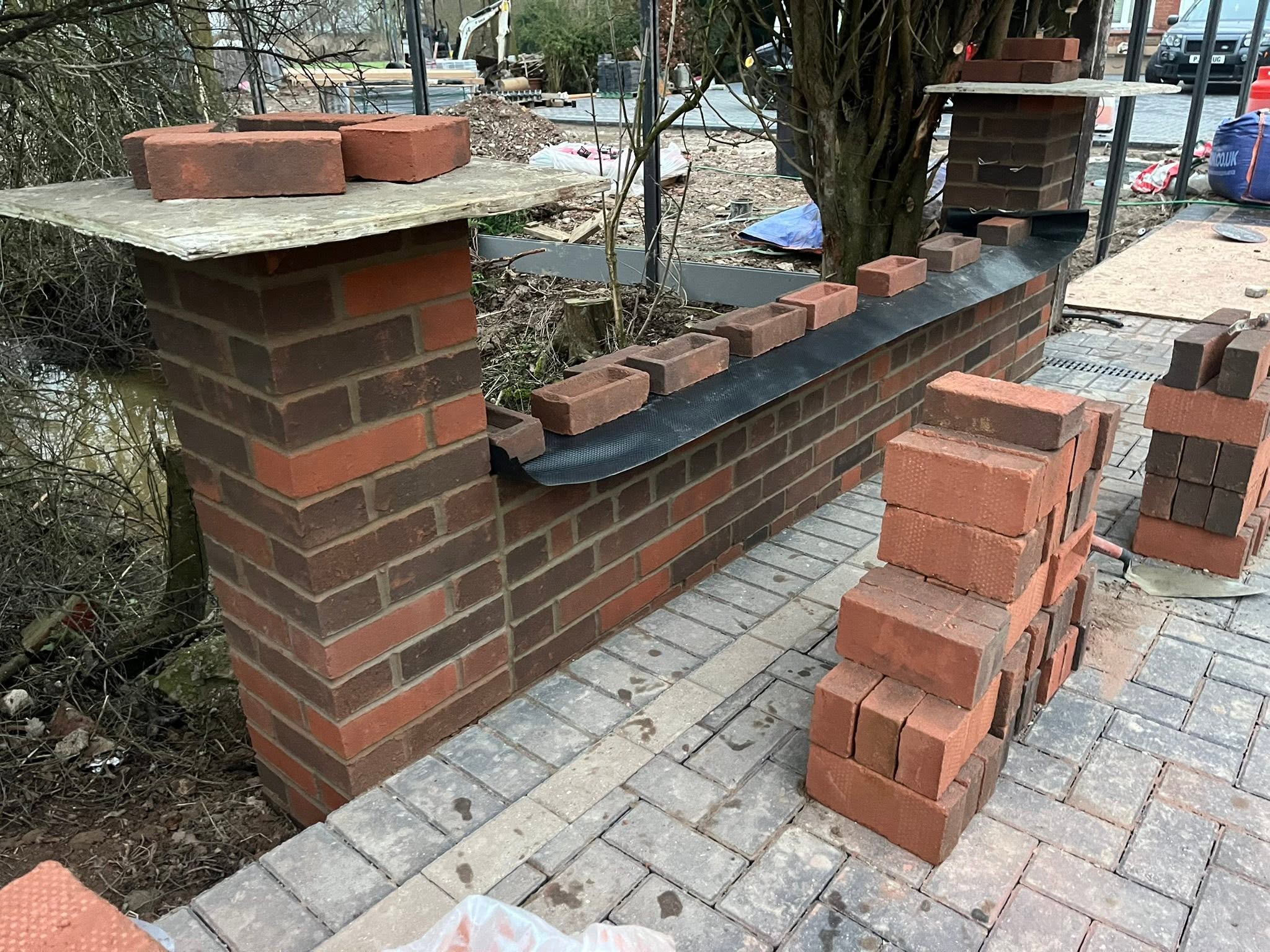 Brick pillars and wall with coping
